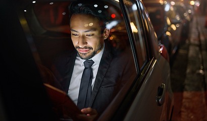 Image showing Travel, tablet and business man in car on social media, internet browsing or working. Transport, night and young male professional with digital technology for networking, web scrolling or research.