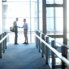 Image showing Business men, handshake or greeting in hotel lobby, modern office or airport lounge in CRM team meeting. Corporate workers, employees or shaking hands in partnership deal, collaboration or agreement