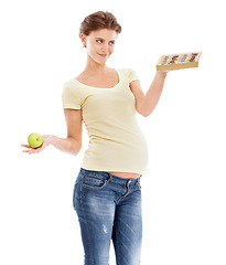 Image showing Pregnant, thinking and diet of woman with candy craving, choice and temptation marketing mockup. Pregnancy belly of girl choosing sweets with contemplating smile and white studio advertising.