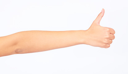 Image showing Woman, hand and thumbs up on studio background in success goals, vote support or opinion on white mockup backdrop. Zoom, model and yes finger gesture in thank you, winner news or good luck motivation