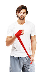 Image showing Red tape on hand for martial arts with man, fitness and mma with boxing for exercise against white background. Sport motivation, fist and fight with athlete, boxer workout with safety and protection