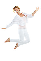 Image showing Woman, excited and jumping happy in studio for freedom, positive mindset energy and isolated in white background. Female, smile and jump in air for happiness motivation, celebration or winner success