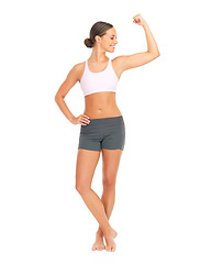 Image showing Sports, fitness and woman with arm muscle in studio isolated on a white background mockup. Strong, power and female model, athlete or body builder flexing bicep after training, workout or exercise