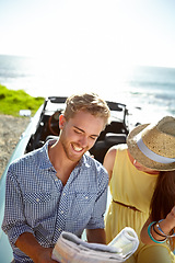 Image showing Road trip, adventure and couple with map by ocean on summer holiday, vacation and weekend getaway on car. Travelling, freedom and man and woman reading paper for directions, navigation and journey