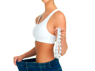 Image showing Diet, weightloss and woman with measuring tape, jeans and tummy tuck with skinny waist, cropped and isolated on white background. Fitness, healthcare and wellness, girl with slim figure measurement.