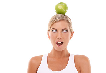 Image showing Woman, wow and apple on head in studio for wellness, diet and balance by white background. Isolated model, fruit and surprise expression face for vitamin c, natural nutrition and healthy organic food