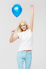 Image showing Woman, balloon celebration and studio portrait with hands in air, happiness and winning by white background. Winner model, celebrate and party at event for success, smile and isolated for motivation