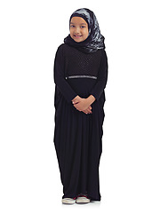 Image showing Islamic clothes, young child and smile standing in white background for culture happiness, religion awareness or empowerment. Muslim girl, happy and religious fashion or hijab isolated in studio