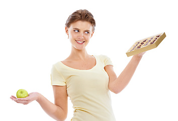 Image showing Thinking, choice and diet decision of woman with candy craving, option and temptation marketing. Nutrition model choosing sweets with contemplating smile in white studio with advertising mockup.