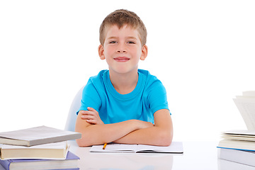 Image showing Portrait, school and education with a boy student in studio isolated on a white background for learning or to study. Children, books and mockup with a male pupil sitting at his desk in a classroom