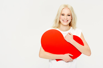 Image showing Heart, shape and portrait of woman in studio for love, sign and care against white background. Face, emoji and girl holding an icon for peace, affection and self love with mockup space, happy and joy