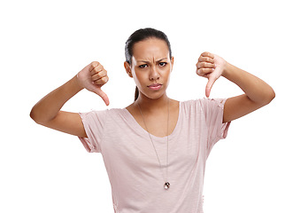 Image showing Woman, upset and thumbs down with unhappy expression for disagreement, wrong or fail against a white background. Portrait of isolated female model showing down thumbs in disapproval, no or failure