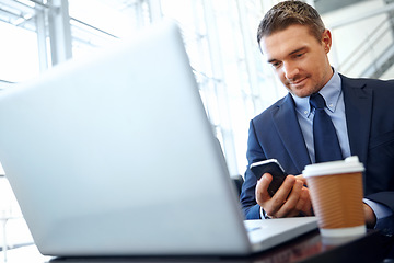 Image showing Businessman, laptop and smartphone with company communication or social media with coffee while working. Contact, online and email with networking and worker in professional corporate lounge