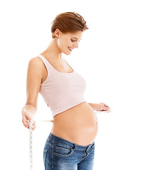 Image showing Woman, pregnancy stomach and measuring tape for baby wellness, healthcare support and lifestyle motivation in white background studio. Mother, pregnancy and maternity wellbeing or measuring belly