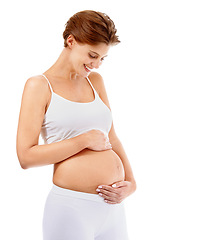 Image showing Pregnancy love, smile and happy woman with stomach on a white background in studio. Happiness, care and pregnant woman smiling at her pregnant abdomen on a studio background with mockup space