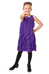 Image showing Fashion, pointing and portrait of child on a white background for youth, glamour and ballroom dancing. Happy, dancer and isolated young girl pointing finger with stylish, beautiful and trendy dress