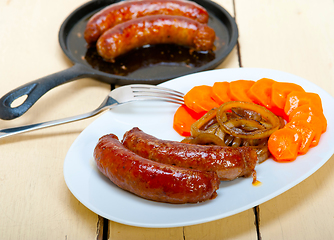 Image showing beef sausages cooked on iron skillet