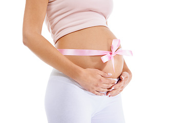 Image showing Pregnant woman, pink ribbon and stomach on studio background of maternity health and wellness. Belly, pregnancy and bow of baby shower, girl announcement and gift of life, fertility and future mother