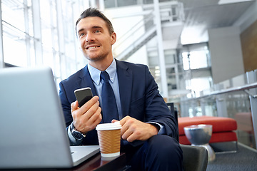 Image showing Businessman, smartphone and laptop in corporate lounge, thinking and digital marketing. Startup, male entrepreneur and ceo with cellphone, social media and planning for advertising and modern office