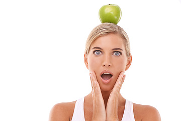 Image showing Woman, surprise and apple on head in studio for wellness, nutrition and balance by white background. Isolated model, fruit and wow face portrait for vitamin c, natural diet and healthy organic food