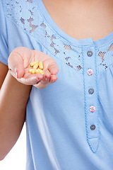 Image showing Hand, medicine and pills with a woman in studio for healthcare, prescription medication or treatment. Tablet, medical and supplements with a female holding vitamins for nutrition, health or cure