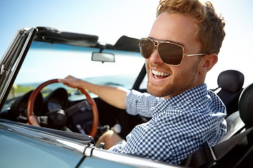Image showing Car road trip, travel and portrait man on holiday adventure, happy transportation journey or fun summer vacation. Flare, sunglasses and driver driving convertible vehicle on Canada countryside tour