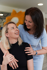 Image showing Two women share a heartfelt embrace while at a preschool, showcasing the nurturing and supportive environment for learning and growth