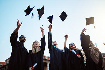 Image showing Graduation, education and success with friends in celebration as a graduate group outdoor, throwing mortar caps. Diversity, university and man and woman students celebrating a college diploma