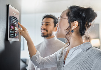 Image showing Smart home technology, wall system and couple with digital dashboard for air conditioning, safety security network or house automation. App software, ui panel and Asian people programming IOT monitor