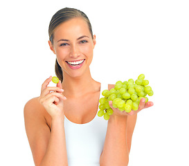 Image showing Health, wellness and woman with grapes in a studio for a healthy snack, nutrition diet or craving. Wellbeing, weightloss and portrait of young female model eating fruit isolated by a white background