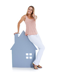 Image showing Woman, thumbs up and home board portrait for real estate, property investment and house vision in studio. Realtor winner, home loan approval and and property management agreement in white background