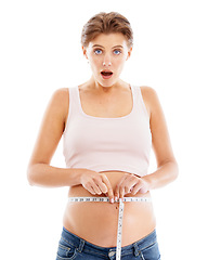 Image showing Portrait of shocked pregnant woman with measuring tape on stomach, excited smile on face and white background. Health, wellness and pregnancy, woman measuring baby growth progress in belly in studio.