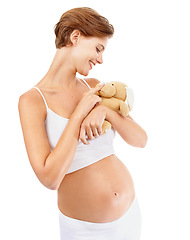 Image showing Pregnant woman, teddy bear and happy pregnancy stomach with a mother excited about motherhood. Child toy, mothers love and mama happiness with a mom smile looking at rabbit doll for children