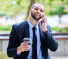 Image showing Businessman, phone call and city park with coffee for energy, conversation or relax on break by trees. Corporate black man, smartphone or communication in metro, networking and espresso in New York