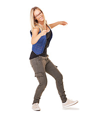 Image showing Woman, studio portrait and dance with fashion, smile and glasses for happiness by white background with style. Confident model, isolated and dancer with trendy jeans, shoes and clothes with wellness