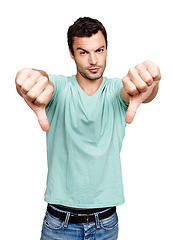 Image showing Thumbs down, man and studio portrait, white background and isolated for wrong sign, poor review or body language. Disappointed guy, hands and bad opinion, rejection emoji and hate feedback of failure