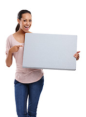 Image showing Woman, studio and pointing with marketing billboard, smile and mock up by white background. Isolated black woman, mockup poster and happiness for branding, blank paper board and advertising portrait