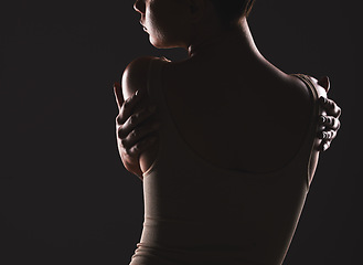 Image showing Beauty, back and dark with a model woman posing in studio on a black background for artistic body positivity. Wellness, health and art with a young female standing to promote self love or self care