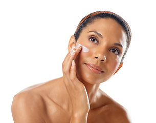 Image showing Face, beauty cream and skincare of woman in studio on a white background. Thinking, makeup cosmetics and young female model apply facial lotion, creme or moisturizer for healthy skin and wellness.