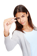 Image showing Woman, portrait and fingers for advertising size, space and small mockup with a smile in studio. Female model in studio showing hand or sign for scale, inch or symbol isolated on a white background