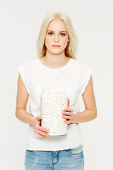 Image showing Portrait, pills and medicine with a model woman holding a jar in studio on a gray background for healthcare. Medical, supplements and medication with a serious young female holding a glass container