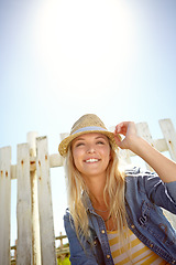 Image showing Woman, hat and blue sky in summer garden, park or mockup lens flare. Sunshine, fashion and female relax at field fence, nature and freedom with happiness in environment for holiday, mock up and smile