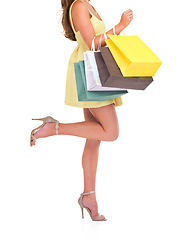 Image showing Woman, bags and shopping for discount, sale and client isolated on white studio background. Female, shopper and customer with boutique items, expensive clothes and retail for fashion and high heels