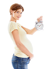 Image showing Pregnancy, clock and portrait of woman in studio holding her stomach waiting for birth of her baby. Maternity, prenatal and pregnant girl model with alarm clock for time isolated by white background.