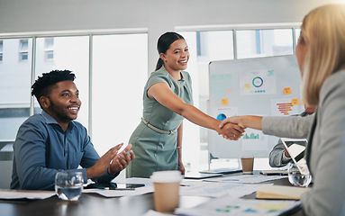 Image showing Business people, woman and handshake at meeting, planning and chart on board for target, success or goal. Corporate finance group, applause and celebration for profit, promotion or vision in New York