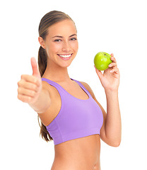 Image showing Apple, thumbs up and fitness of woman in studio isolated on white background. Face, portrait and female model with hand gesture and fruit for healthy diet, wellness or nutrition, vitamins or minerals