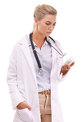 Image showing Woman pharmacist reading medicine table on a white background with focus for pharmaceutical healthcare. Doctor hand holding pills or container thinking of drugs risk or medical brand in studio