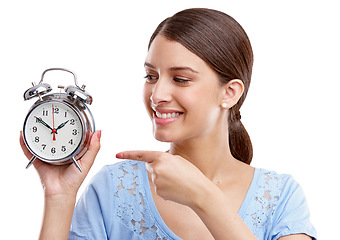 Image showing Clock, time and pointing with a model woman in studio isolated on a white background for alarm or reminder. Alarm clock, point and schedule with a young female on blank space for a deadline