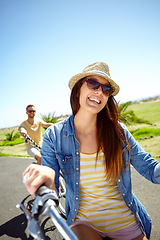 Image showing Cycling, travel and woman on couple vacation, summer holiday fun outdoor riding on blue sky background. Bicycle, smile and happy date with partner on bike ride, freedom and happiness with love in sun