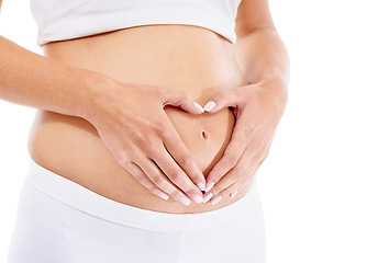 Image showing Pregnant woman, hands and heart shape in studio for baby, love and security support in white background studio. Pregnancy wellness, maternity and hand frame abdomen for infant healthcare or growth